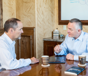 John Ramstead in conversation with a client at a table